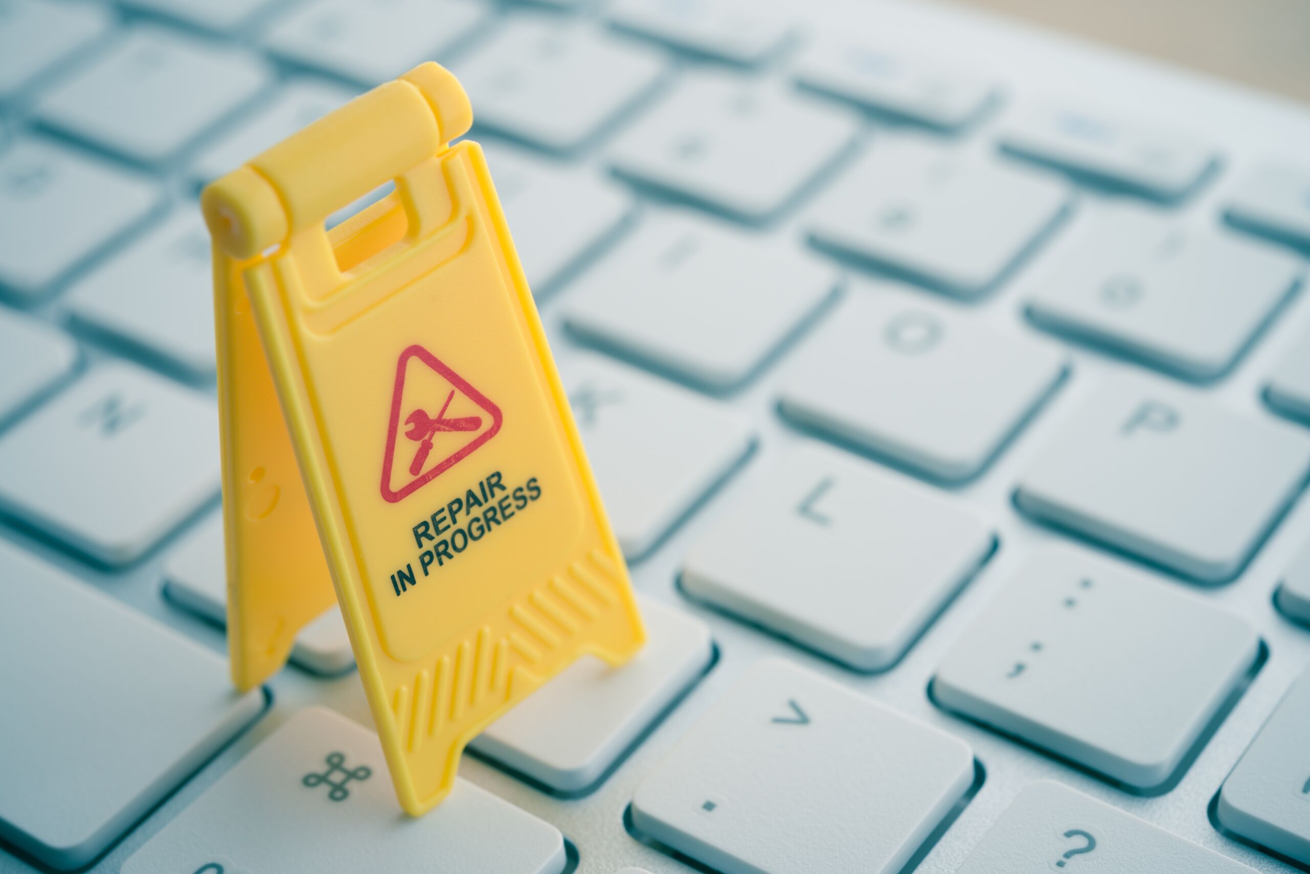 work laptop maintenance and repair underway sign on a keyboard